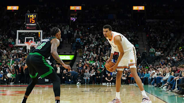Dec 31, 2023; San Antonio, Texas, USA; San Antonio Spurs center Victor Wembanyama (1) faces off against Boston Celtics forward Oshae Brissett (12) in the second half at Frost Bank Center.